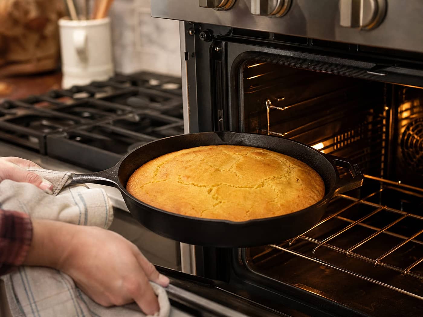 Lodge skillet with cornbread near an oven