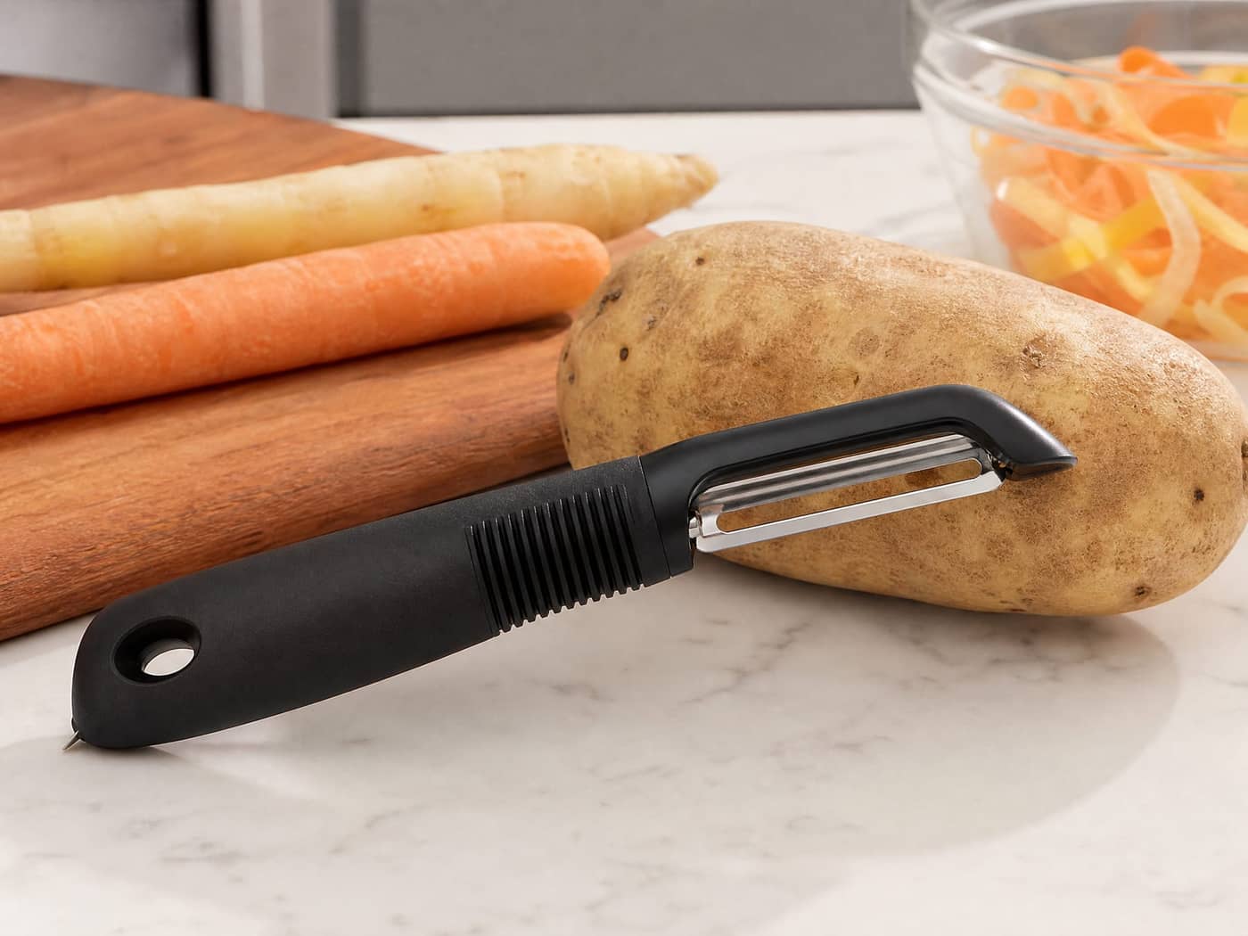 OXO swivel peeler on a cutting board