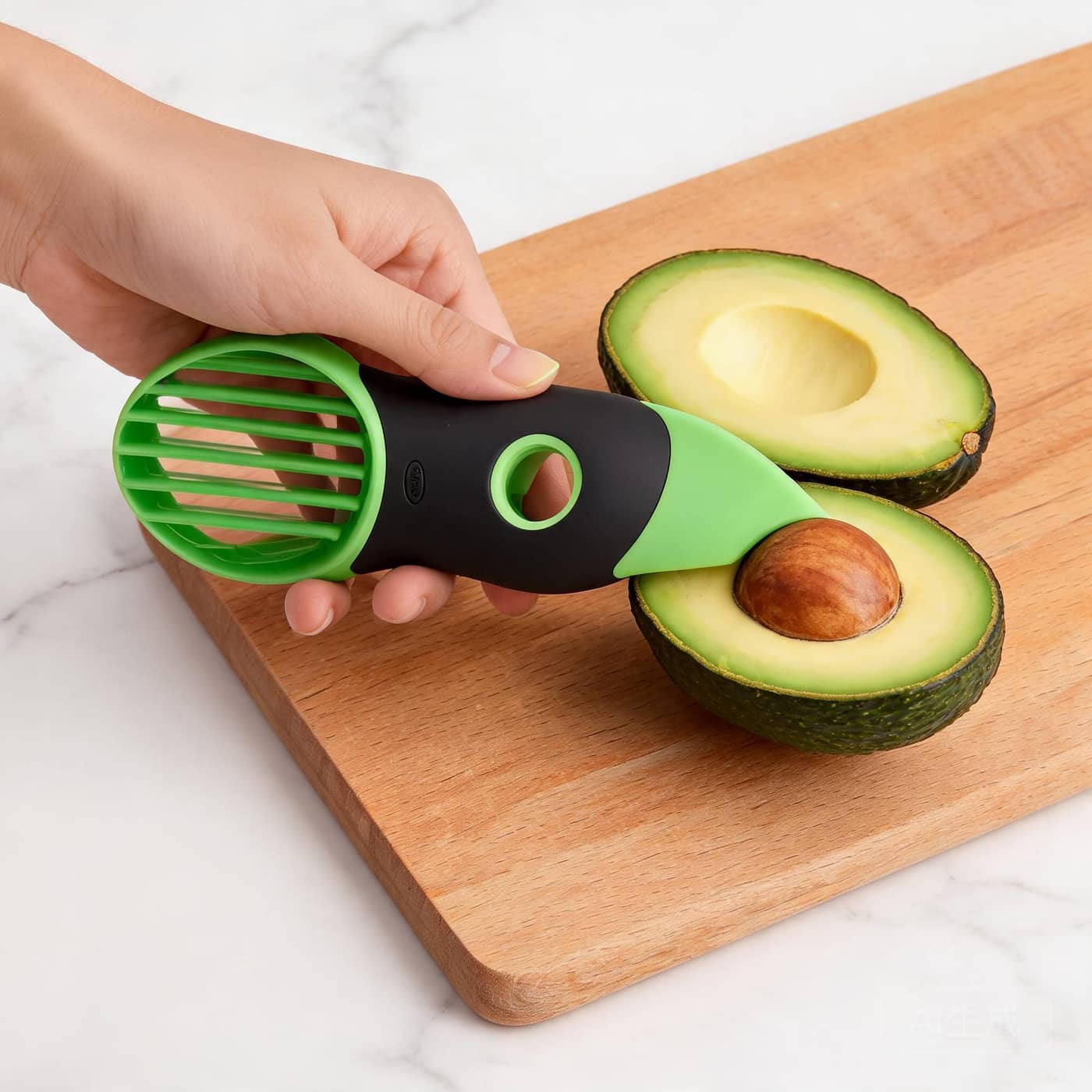 OXO avocado slicer held against an avocado