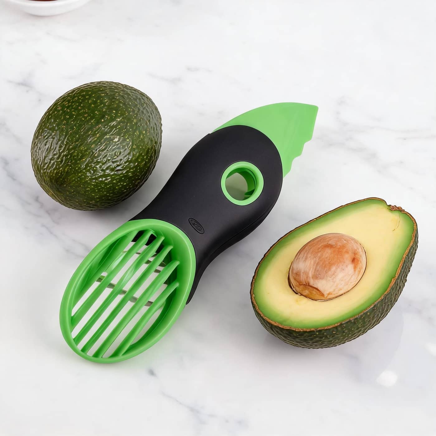 OXO Good Grips avocado slicer beside avocados